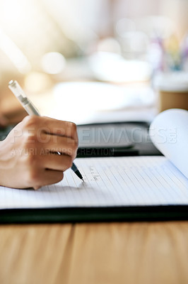 Buy stock photo Cropped shot of a businesswoman writing something in her notepad