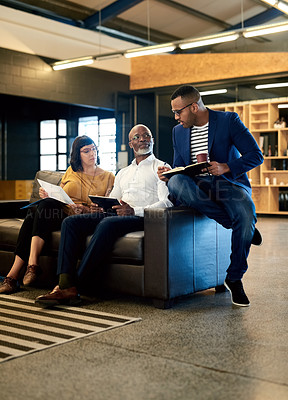 Buy stock photo Shot of a group of designers having a discussion in an office
