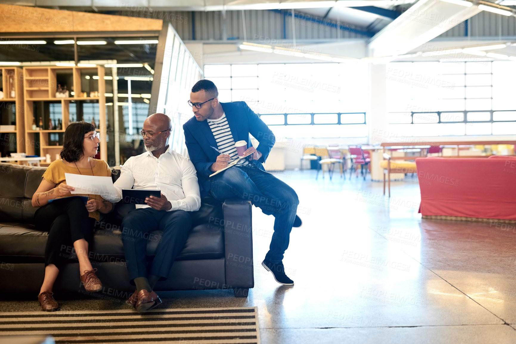 Buy stock photo Shot of a group of designers having a discussion in an office