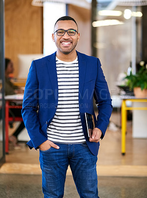 Buy stock photo Shot of a handsome young designer standing in his office