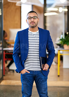 Buy stock photo Shot of a handsome young designer standing in his office
