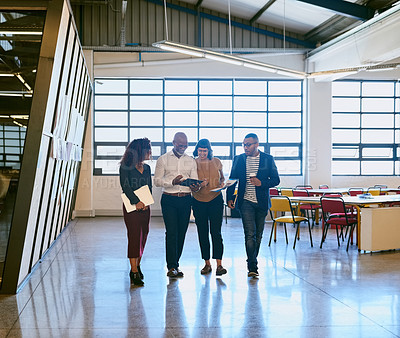 Buy stock photo Shot of a group of designers having a discussion while walking through a office