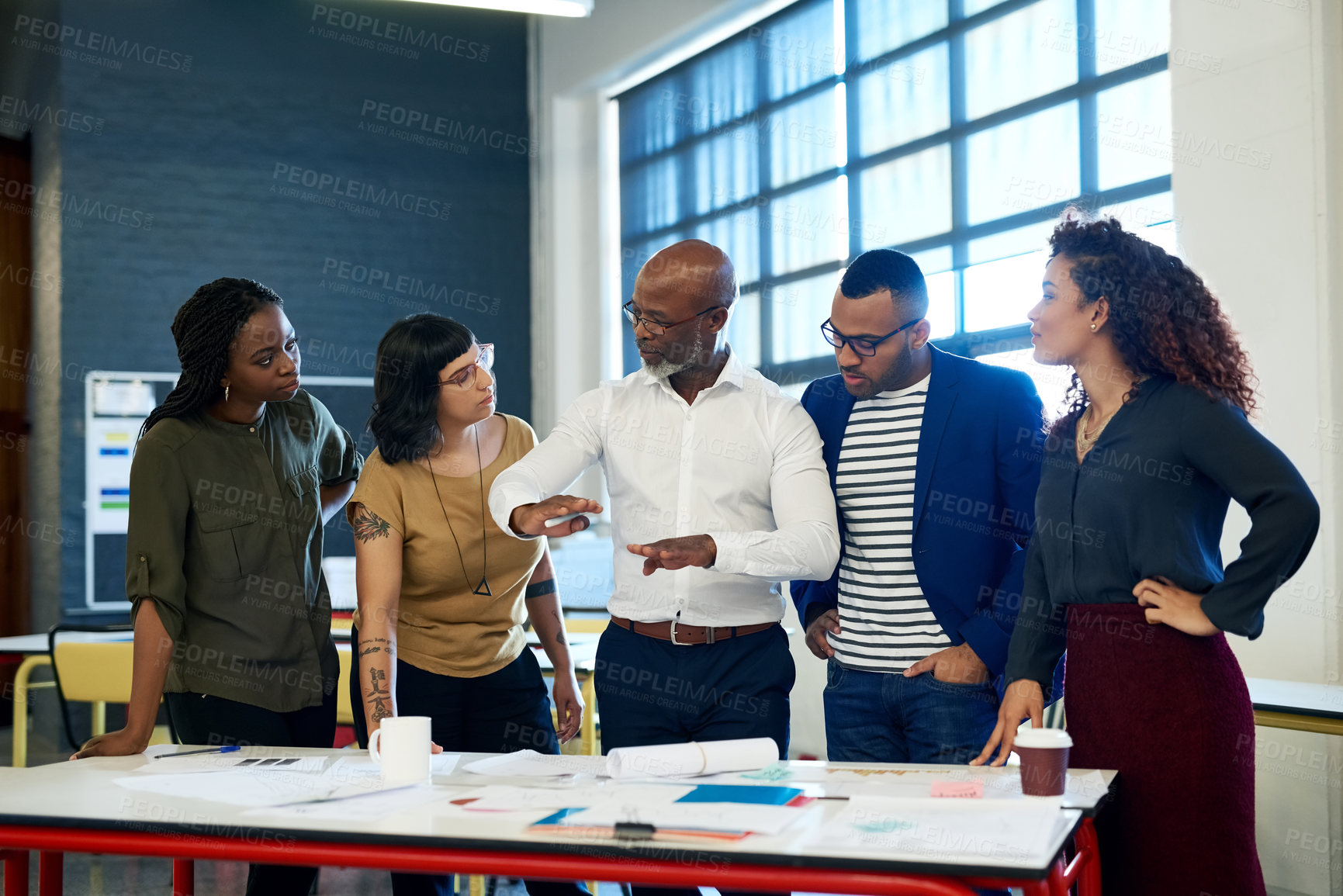 Buy stock photo Business people, group and discussion with documents at startup for meeting, thinking and listening to ideas. Men, women and teamwork in collaboration, paperwork and African leader at creative agency