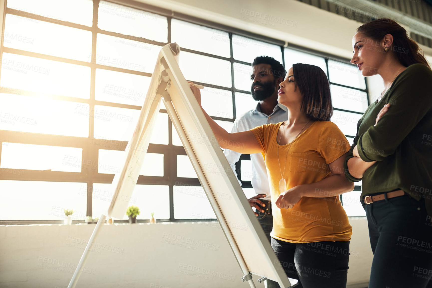 Buy stock photo Shot of a group of businesspeople brainstorming together in an office