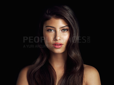 Buy stock photo Studio shot of a beautiful woman posing against a black background