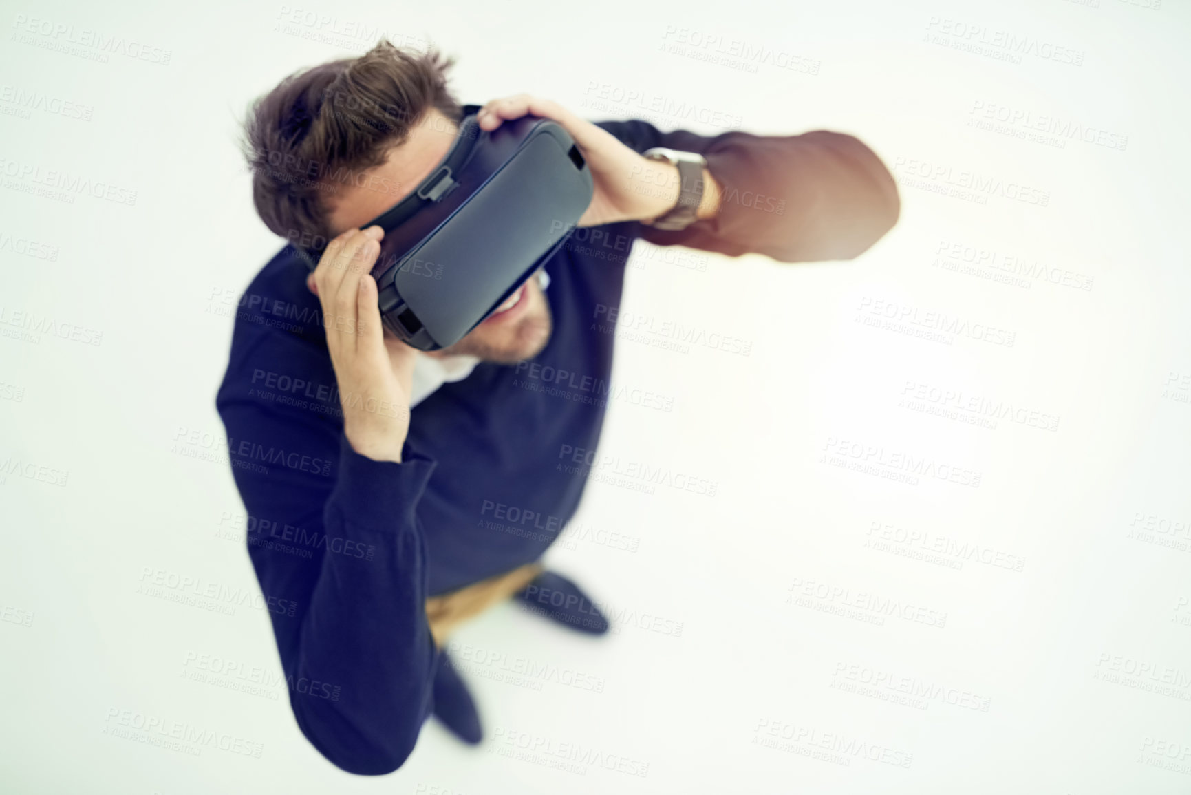 Buy stock photo High angle shot of a businessman wearing a VR headset in an office