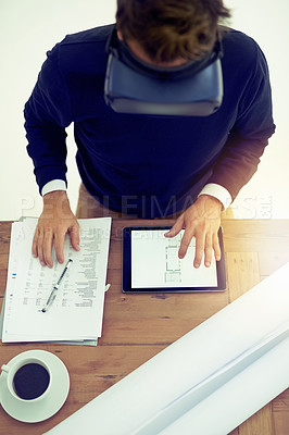 Buy stock photo High angle shot of a businessman wearing a VR headset while working in an office