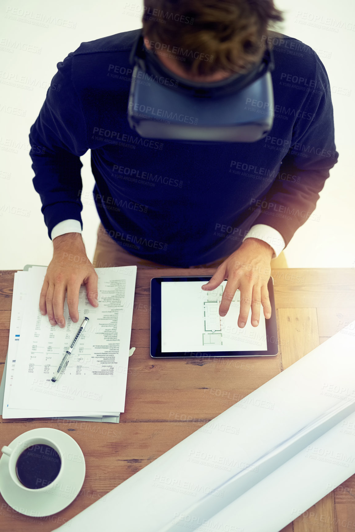 Buy stock photo High angle shot of a businessman wearing a VR headset while working in an office