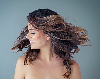 Buy stock photo Cropped shot of a beautiful young woman posing against a grey background in the studio