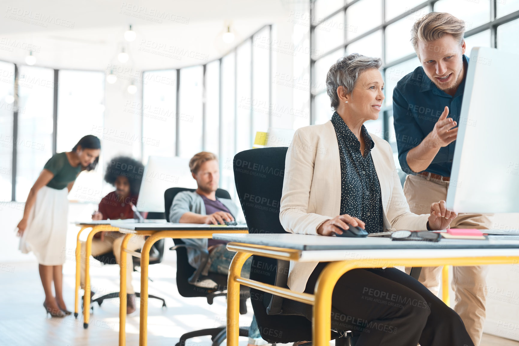 Buy stock photo Shot of a group of creative designers hard at work in their modern office