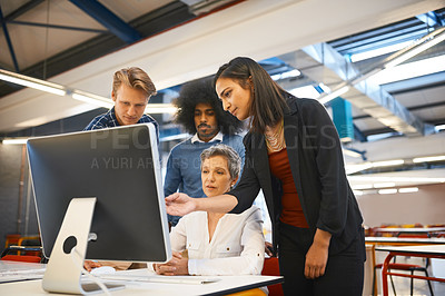 Buy stock photo Cropped shot of a team of designers working together on a computer in their office