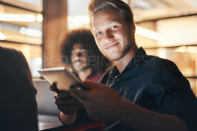 Buy stock photo Portrait of a designer using his digital tablet while sitting in a meeting