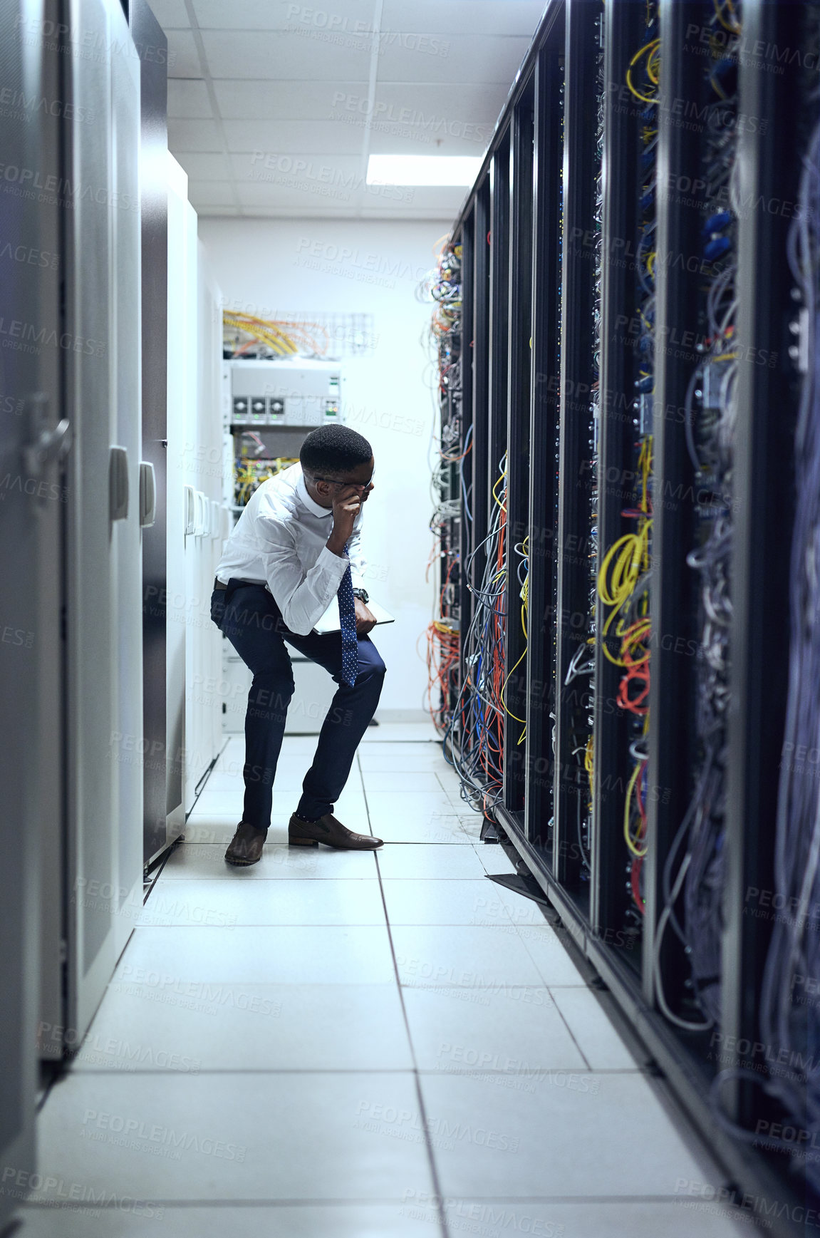 Buy stock photo Cropped shot of a IT technician working and checking if all the servers are up and running
