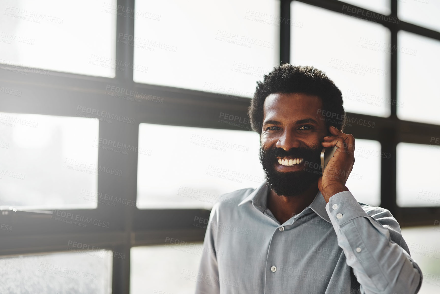 Buy stock photo Portrait, window and phone call with a business man in the office for communication or networking. Face, happy and contact with a happy male employee networking in the workplace during his break
