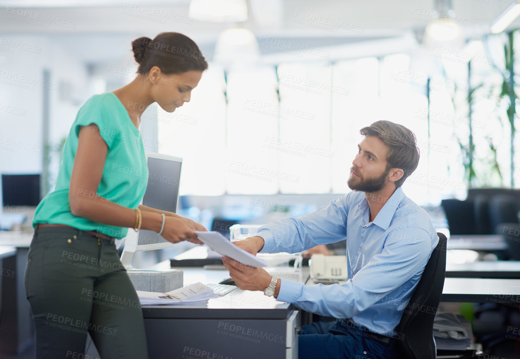 Buy stock photo Cropped shot of an attractive young businesswoman handing her boss some paperwork