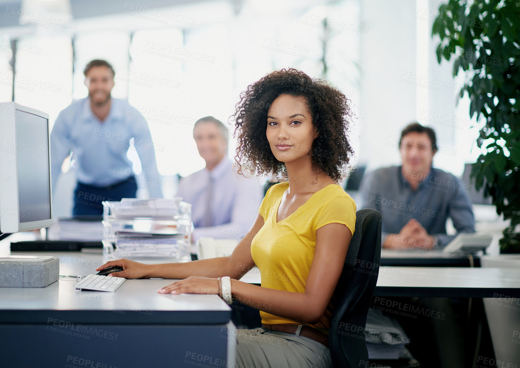 Buy stock photo Portrait of an attractive young businesswoman sitting in an office with her colleagues in the background
