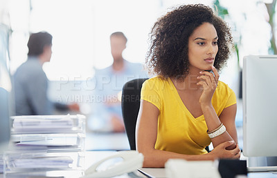Buy stock photo Shot of an attractive young businesswoman working in an office with her colleagues in the background