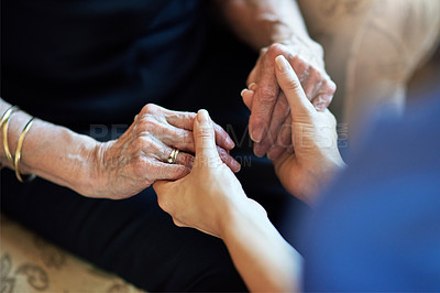 Buy stock photo Cropped shot of a nurse holding an elderly woman’s hands compassionately