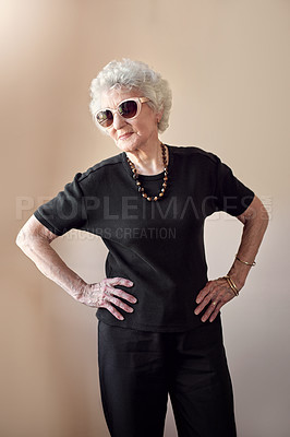 Buy stock photo Shot of a cool senior woman wearing sunglasses and posing with attitude