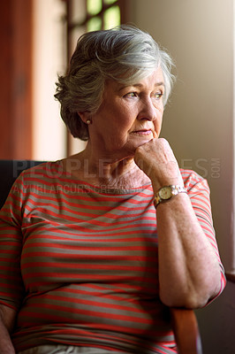 Buy stock photo Shot of a senior woman looking thoughtful at home