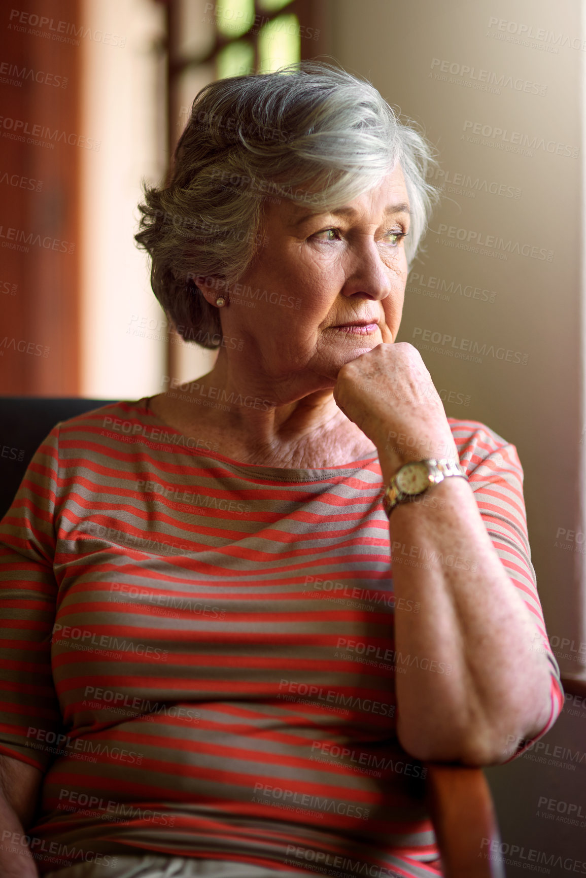Buy stock photo Shot of a senior woman looking thoughtful at home