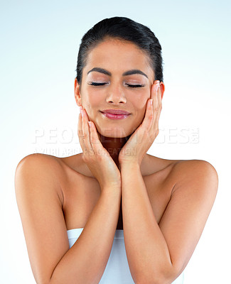 Buy stock photo Studio shot of a beautiful young woman posing against a blue background