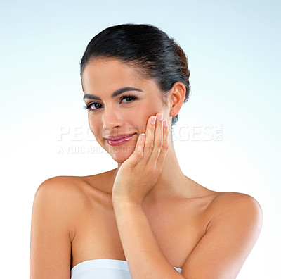 Buy stock photo Studio shot of a beautiful young woman posing against a blue background