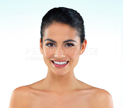 Buy stock photo Studio shot of a beautiful young woman posing against a blue background