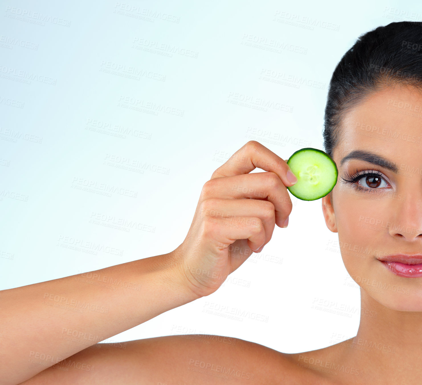 Buy stock photo Cucumber, skincare and half face of woman in studio with natural, revitalizing or facial routine. Portrait, space and person with vegetable for dermatology treatment for glow by white background.