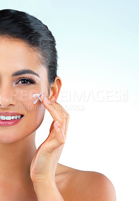 Buy stock photo Woman, beauty and portrait with cream in studio for wellness, glow and mock up space by blue background. Girl, model and person with cosmetics, moisturizer and dermatology with skincare in Mexico