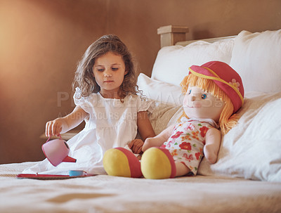 Buy stock photo Shot of an adorable little girl pretending to have a tea party with her doll at home