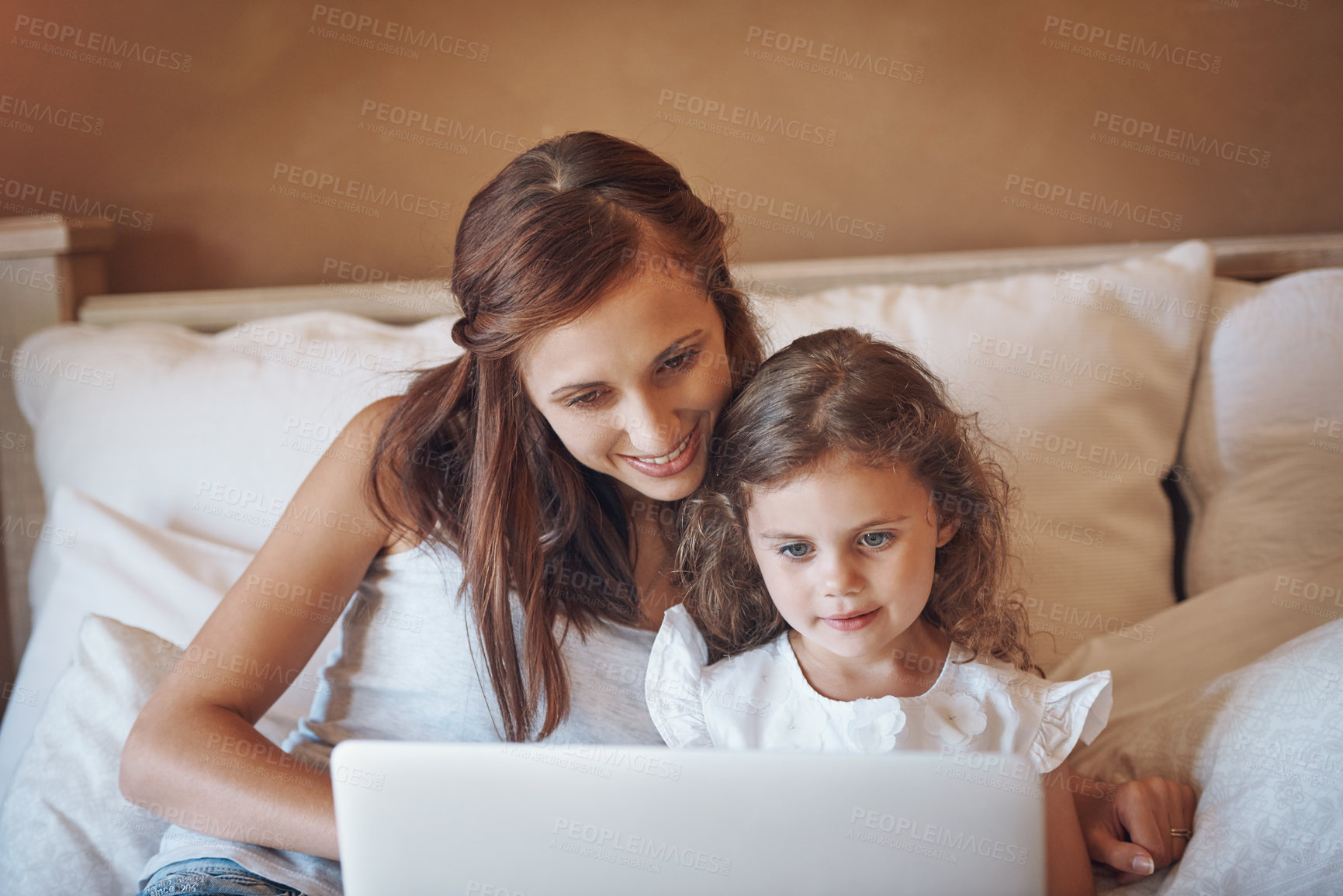 Buy stock photo Mother, kid and relax on bed with laptop for streaming subscription, cartoon and online video in home. Happy family, woman and girl in bedroom with technology for social media, bonding and child film