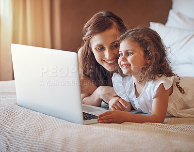 Buy stock photo Mother, child and relax in bedroom with laptop for streaming subscription, cartoon and online video in home. Happy family, woman and girl on bed with technology for social media, bonding and kid film