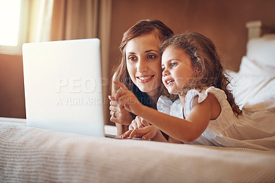 Buy stock photo Mother, child and pointing to laptop in home for streaming subscription, cartoon and online video on bed. Happy family, woman and girl in bedroom with technology for social media, bonding or kid film