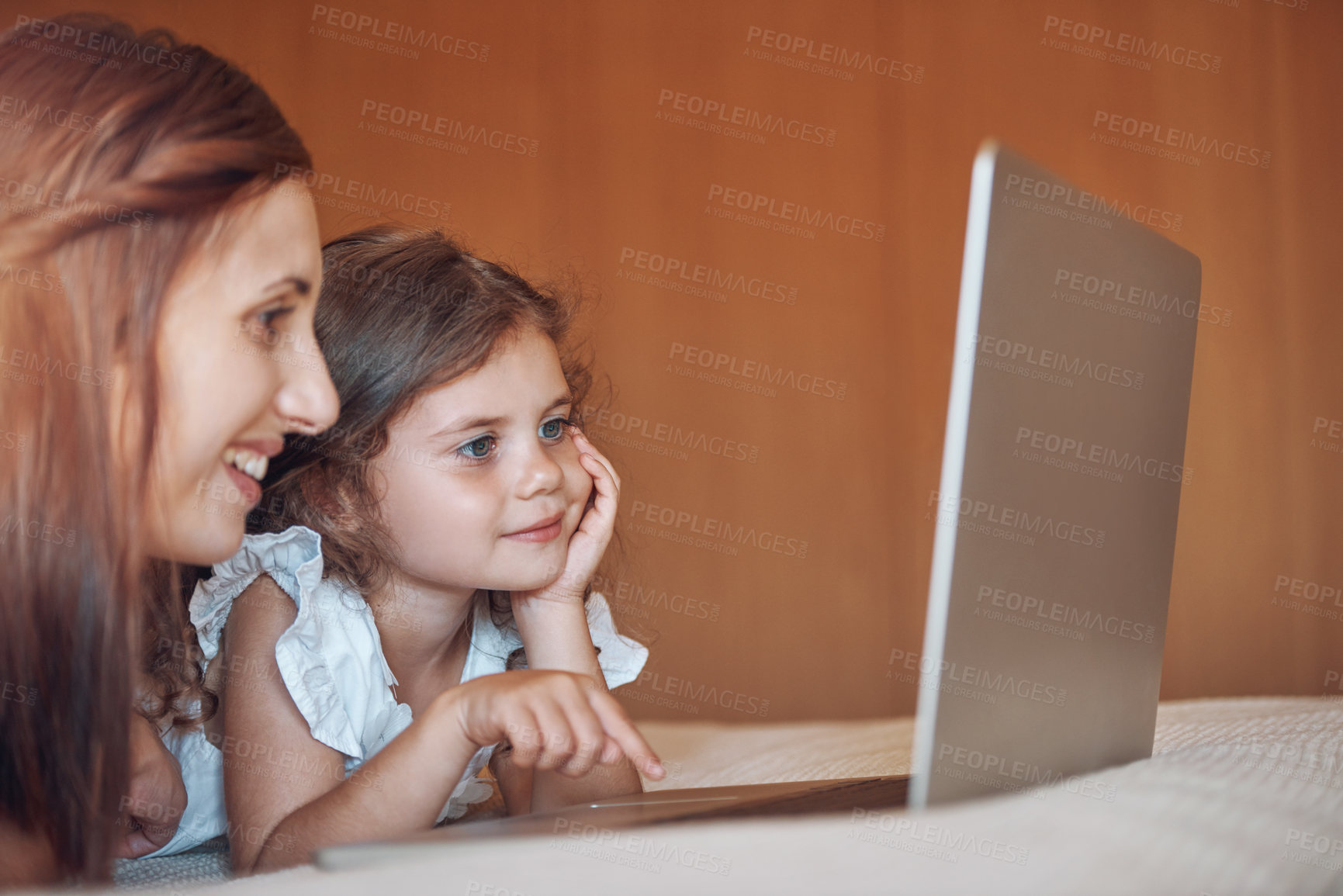 Buy stock photo Mother, girl child and laptop in bedroom for playing a game, educational cartoon or online video in home. Happy family, woman and kid on bed with technology for social media, bonding or watching film