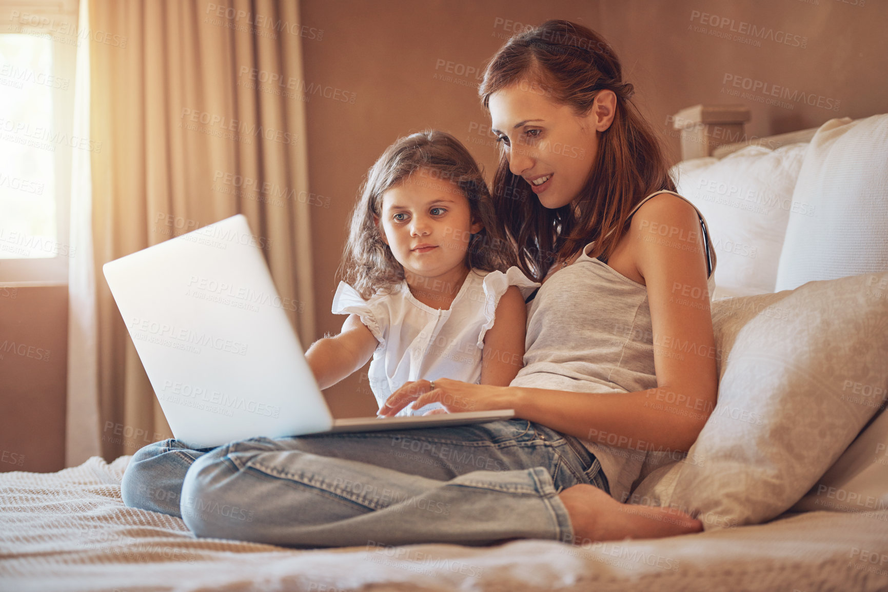 Buy stock photo Mother, girl and laptop in home for streaming movies, bonding and relationship together on bed. Woman, child and tech in apartment for tv show, cartoon or social media with relax and subscription