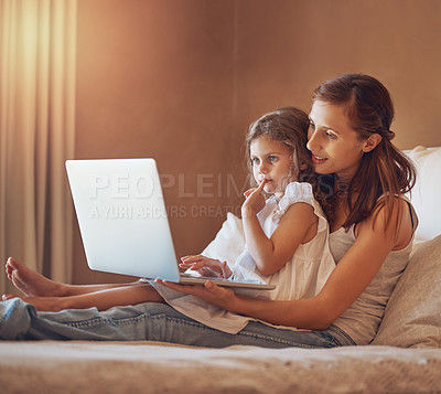 Buy stock photo Mom, girl and technology in home for cartoon streaming, bonding and relationship together on bed. Woman, child and laptop in apartment for tv show, movies or social media with relax and subscription