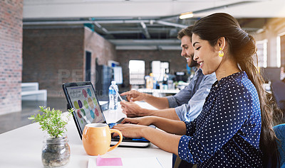 Buy stock photo Teamwork, office and woman at typing at desk with laptop, smile and man at creative agency, working on project together. Digital, partnership and happy employees or business partner at design startup