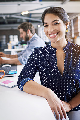 Buy stock photo Portrait of a young designer working in an office with her colleague in the background