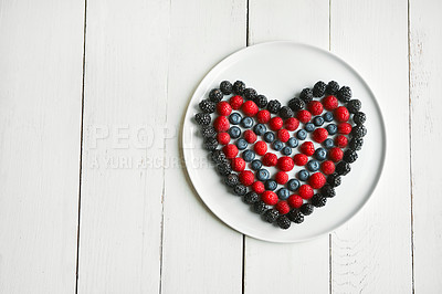 Buy stock photo High angle shot of berries in the shape of a heart on a plate