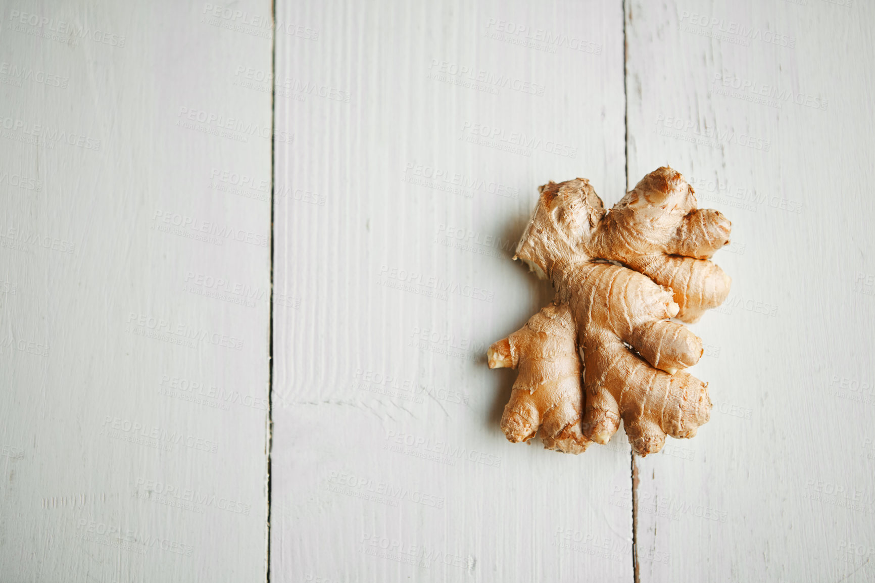 Buy stock photo High angle shot of fresh ginger on a table