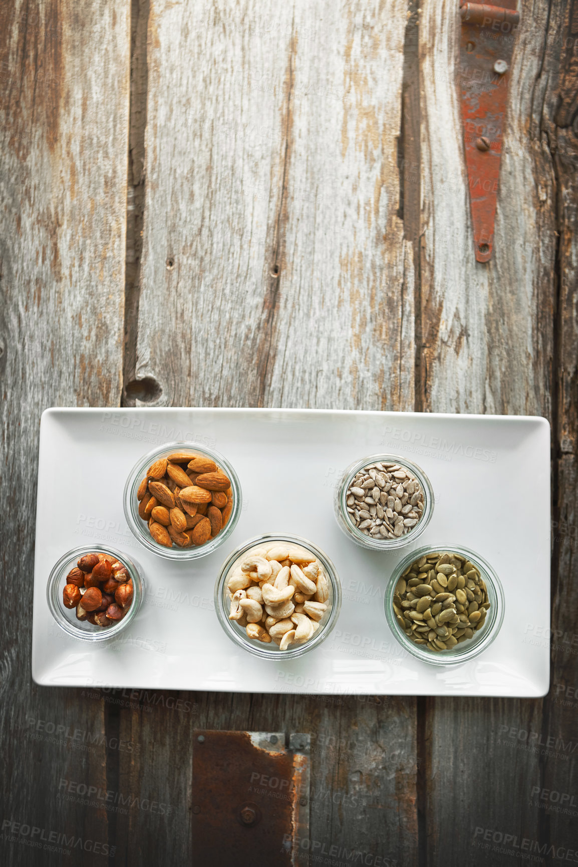 Buy stock photo High angle shot of bowls of various nuts on a table