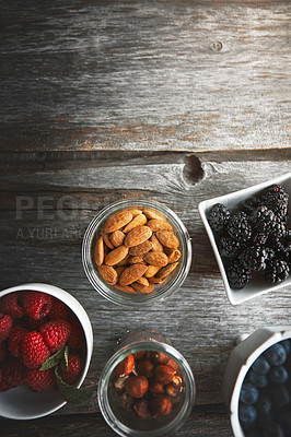 Buy stock photo High angle shot of a selection of nuts and berries on a table