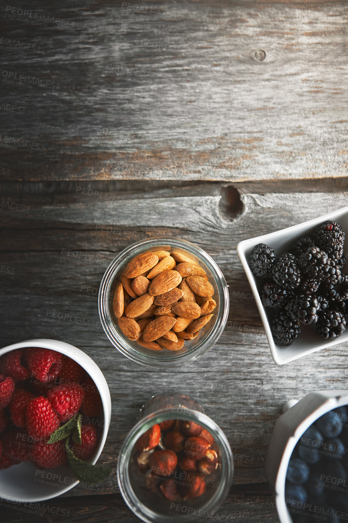 Buy stock photo High angle shot of a selection of nuts and berries on a table