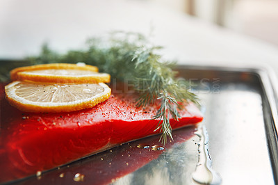 Buy stock photo Shot of a raw piece of meat garnished with slices of lemon