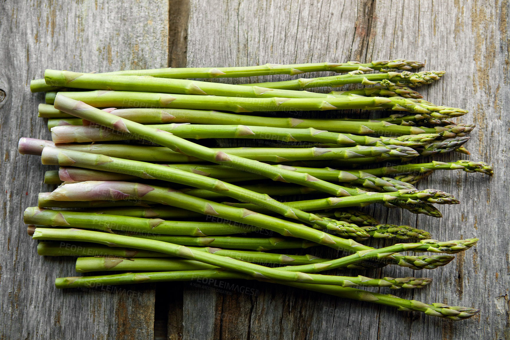 Buy stock photo Asparagus, kitchen and diet on table for nutrition, lunch or product with wellness for health. Organic vegetable, cooking and above for benefit on counter, detox or meal prep for vegan food in home