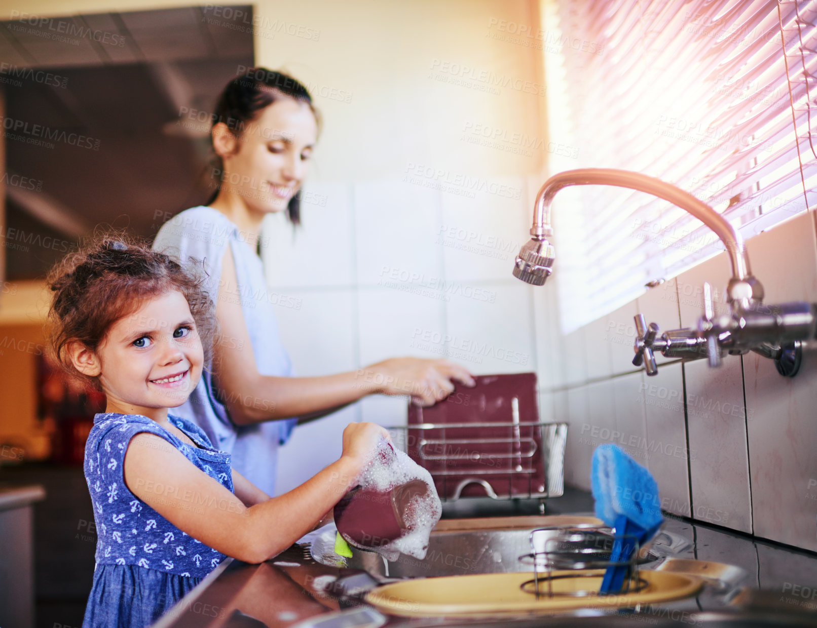 Buy stock photo Mother, girl and portrait for cleaning dishes in home, learning hygiene and happy child in kitchen. Mom, daughter and washing plates in childhood routine, soap splash and helping with housework