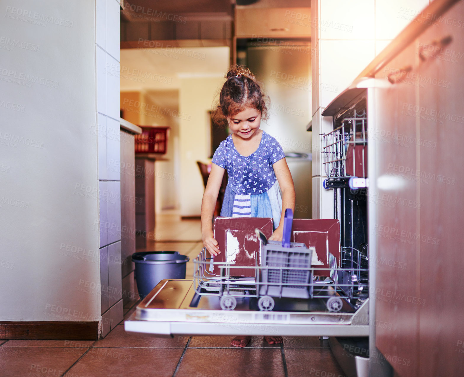 Buy stock photo Help, dishwasher and girl child in kitchen with happy growth, development with learning routine with chores. Housekeeping, smile and kid with confidence, cleaning dishes and loading machine in home