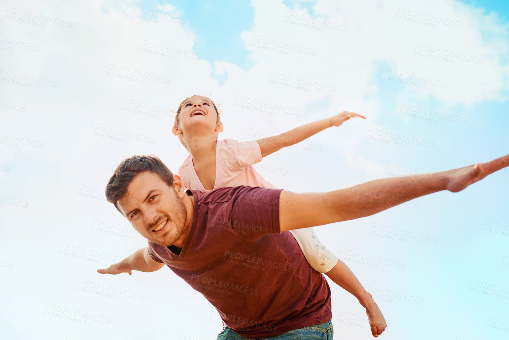 Buy stock photo Piggyback, portrait and kid with airplane on man for outdoor adventure, fun and pretending to fly. Low angle, father and daughter with game by blue sky for family love, weekend and bonding in summer