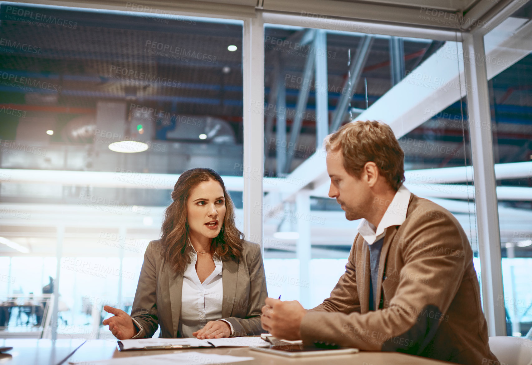 Buy stock photo Cropped shot of two businesspeople working together in the boardroom